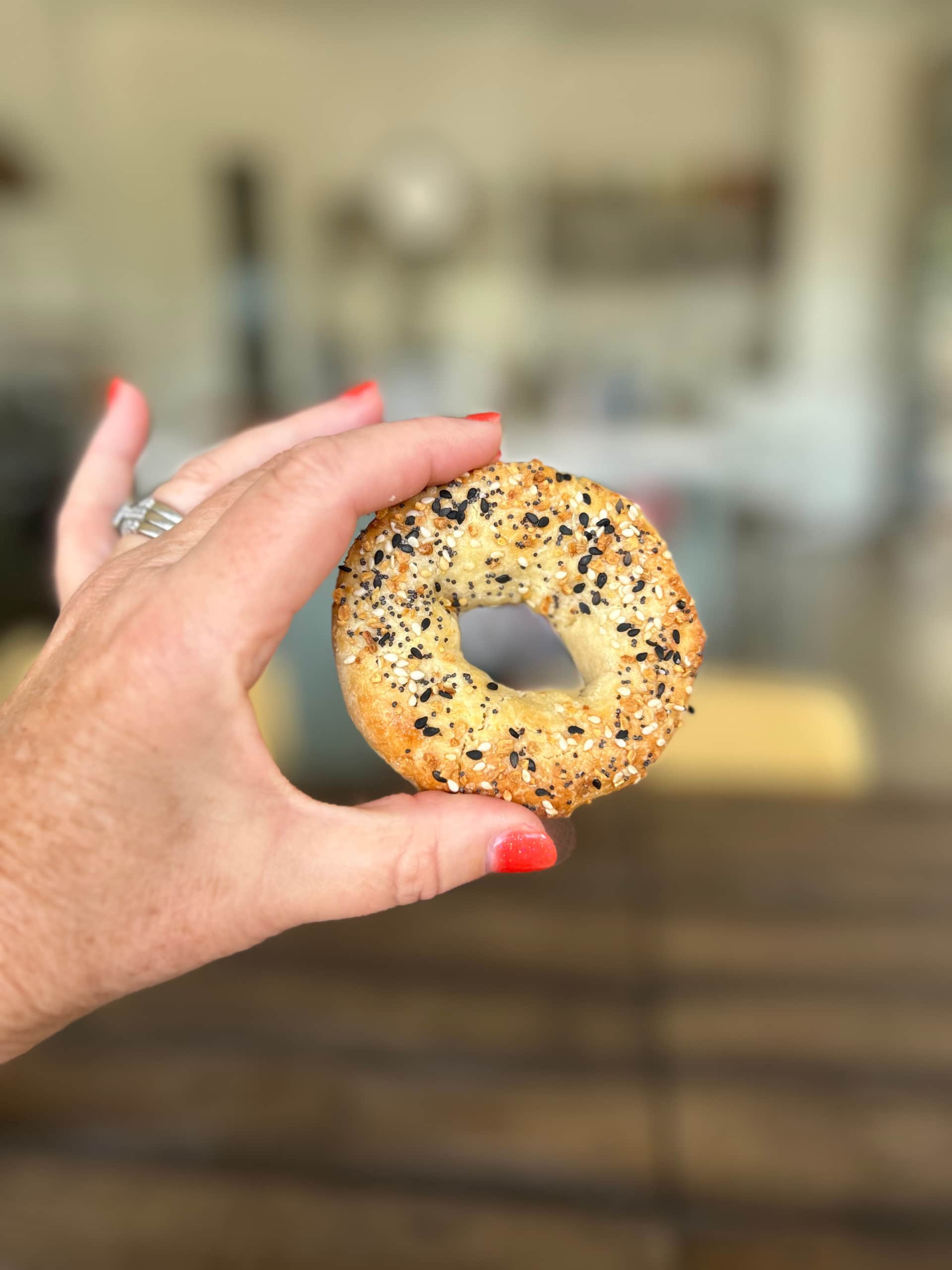 hand holding almond flour bagel