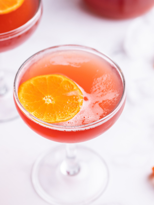 amaretto cranberry kiss cocktail with orange garnish