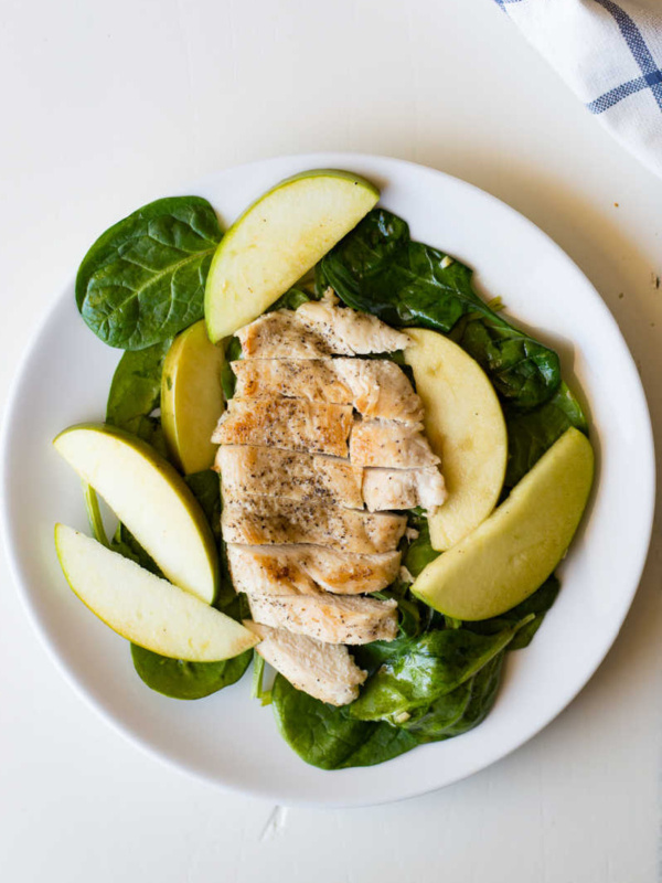 apple spinach chicken on a white plate