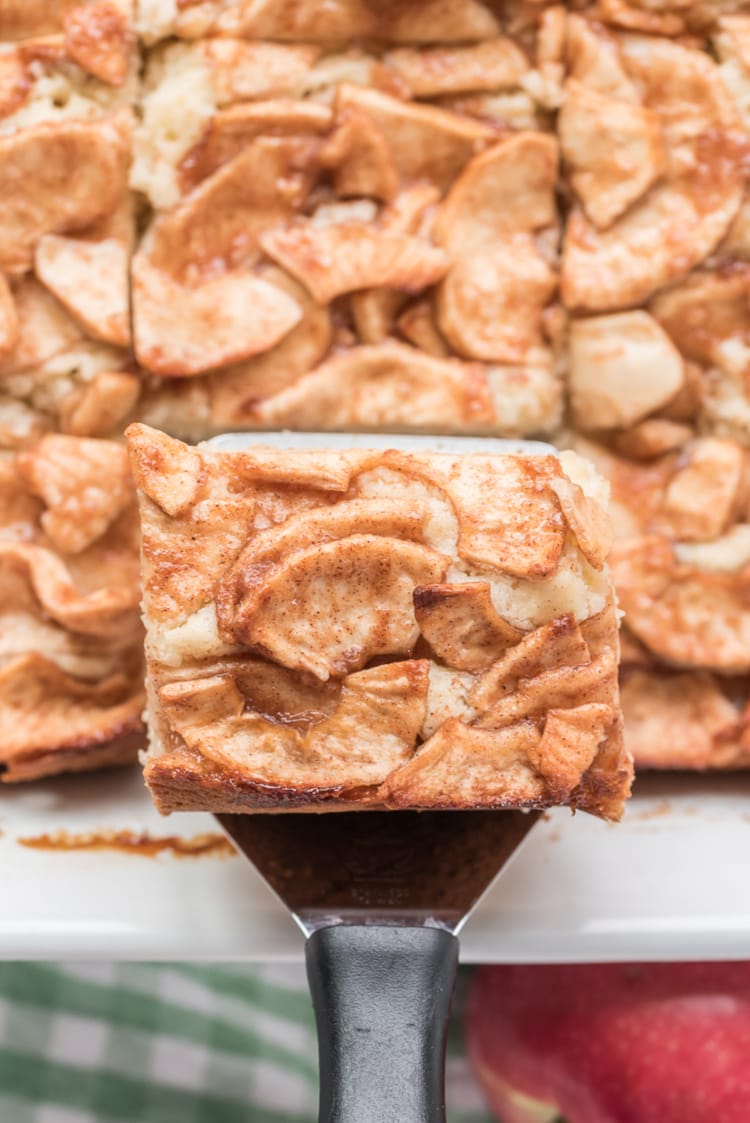 spatula taking out slice of apple coffee cake out of pan