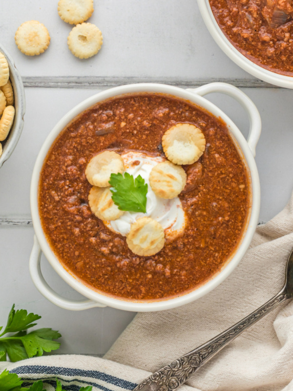 bowl of back bay chili with sour cream and crackers