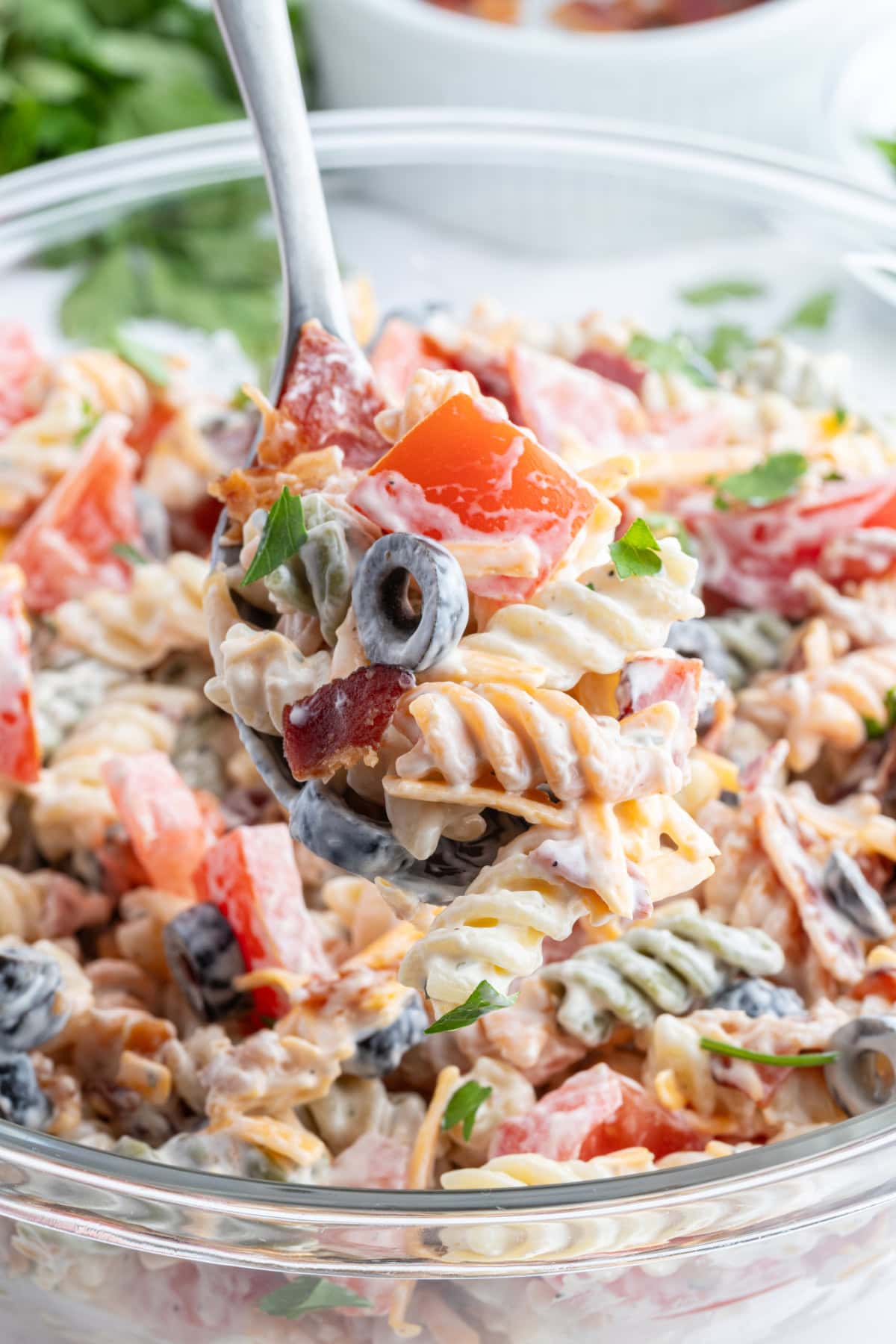 bacon ranch pasta salad with spoon in bowl