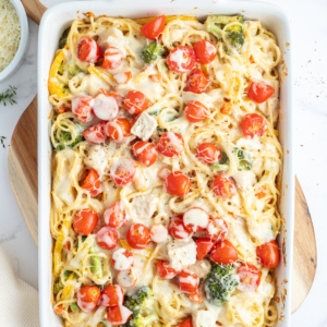 baked lemon chicken spaghetti primavera in a baking dish