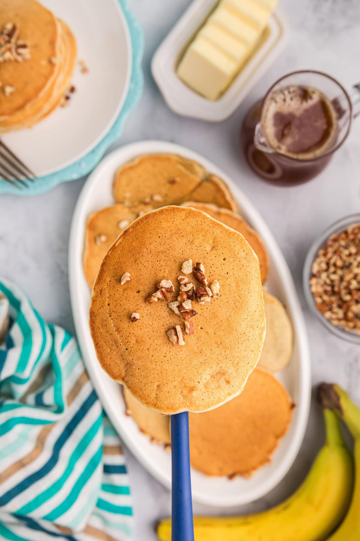 banana pecan pancake on a spatula