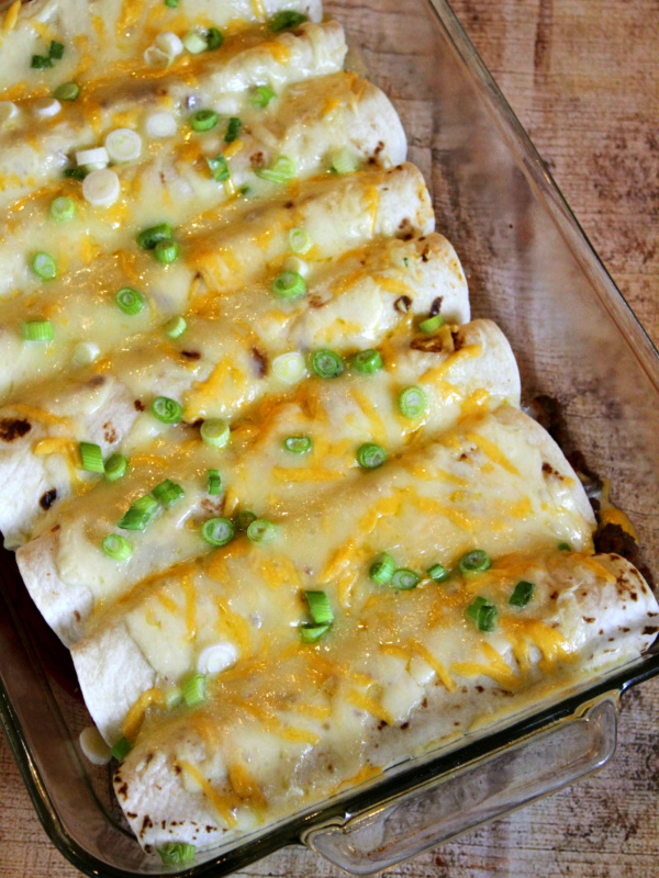 overhead shot of beef burrito casserole with melted cheese and green onions on top