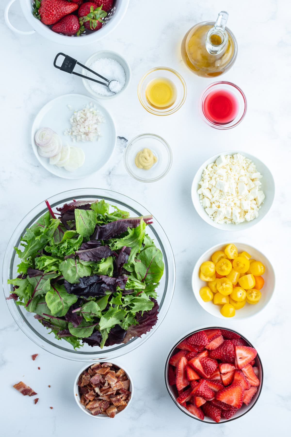 ingredients displayed for making berry bacon and tomato salad