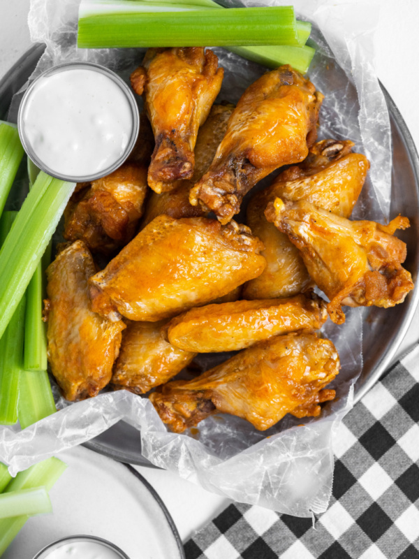 plate of buffalo wings with celery and blue cheese dressing