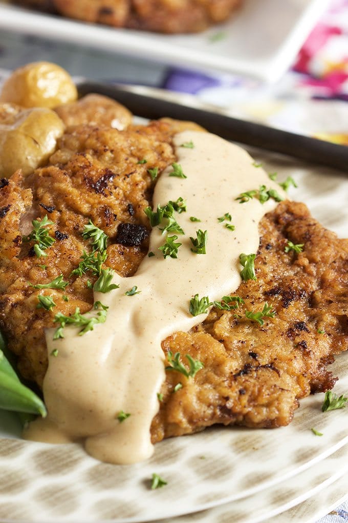 Chicken Fried Steak topped with gravy displayed on a polka dot plate