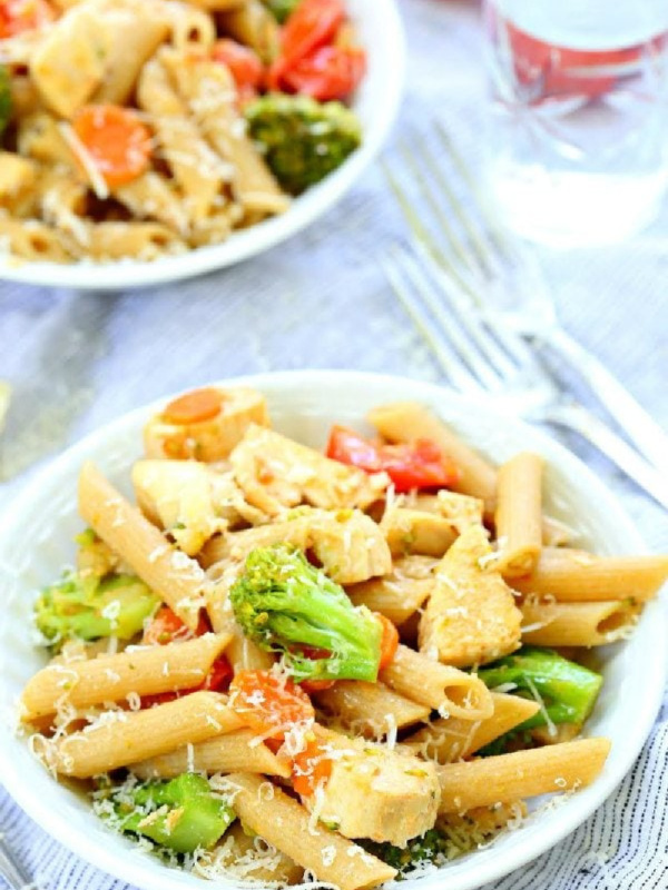 bowl of pasta with vegetables on a whit board