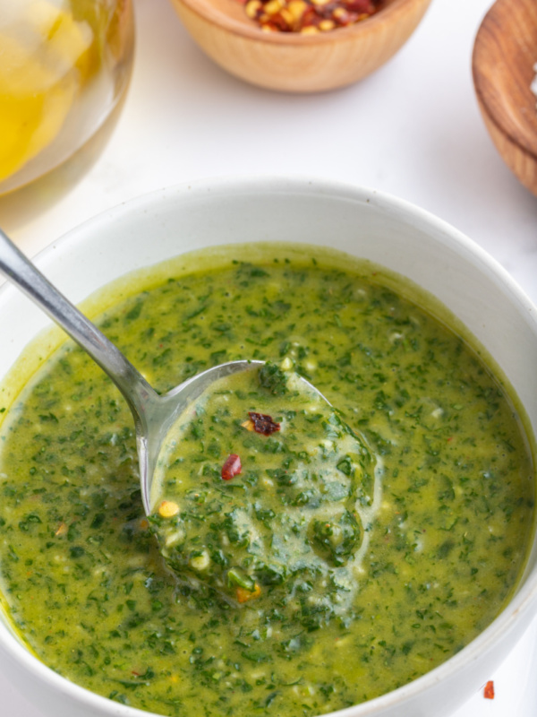 bowl of chimichurri sauce with spoon inside it