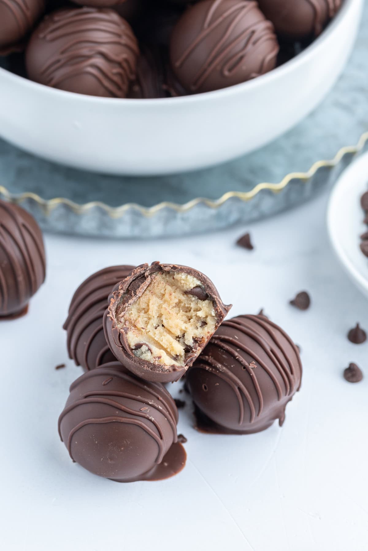 a few chocolate chip cookie dough truffles with one bite taken out