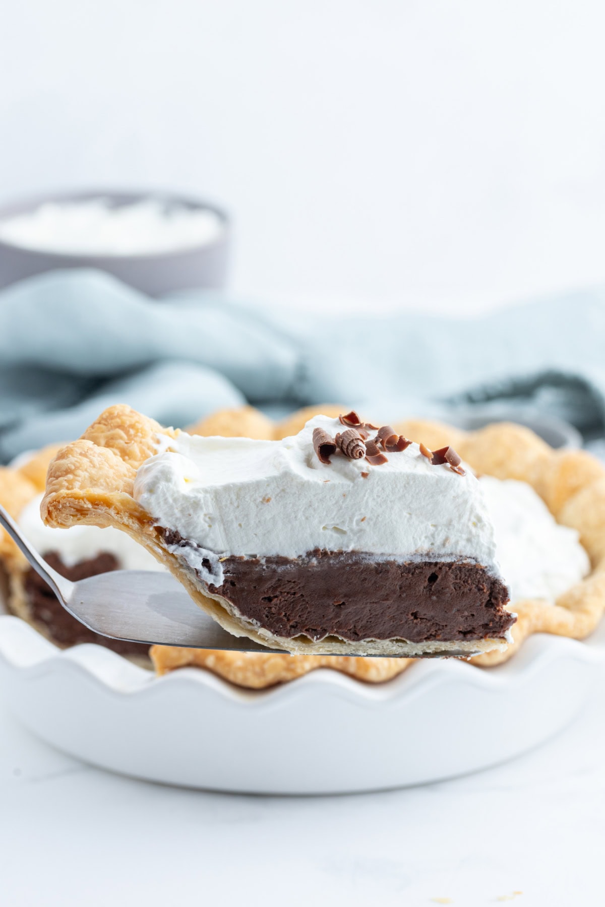 spatula holding up slice of chocolate cream pie