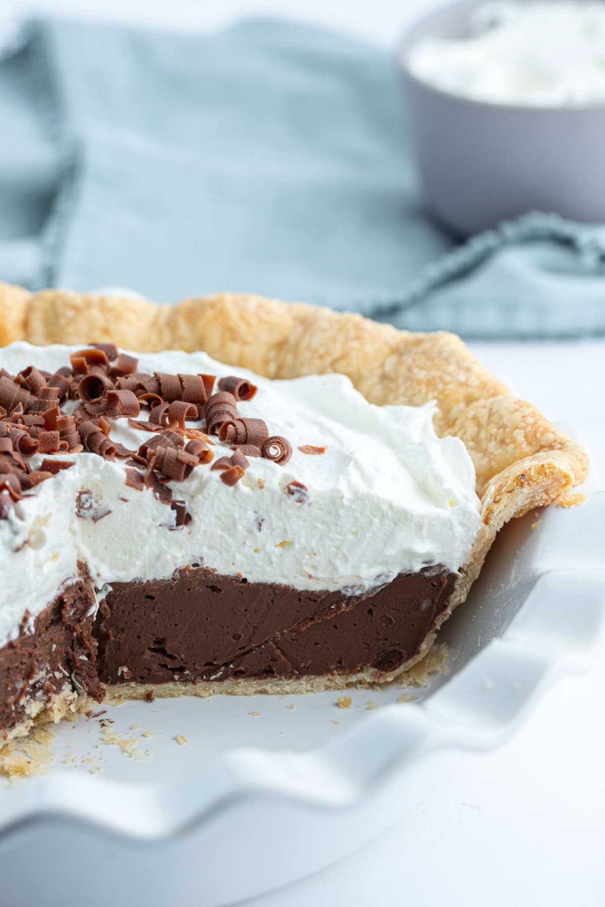 chocolate cream pie with large slice taken out of it