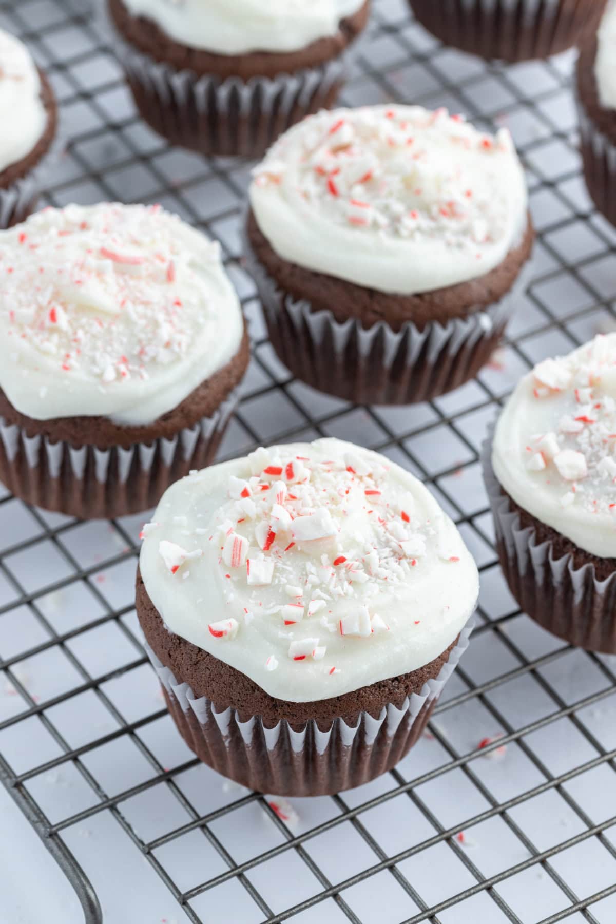 chocolate cupcakes with peppermint icing on cooling rack