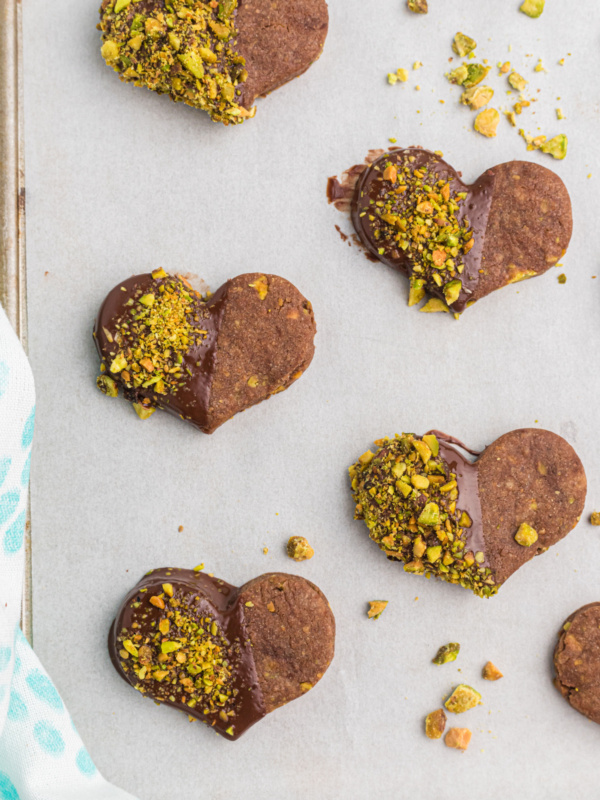 chocolate pistachio cut out cookie hearts dipped in chocolate and pistachios