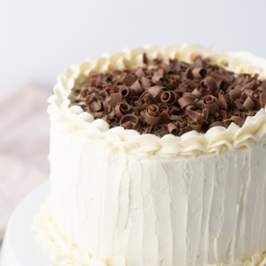 wedding cake with white frosting and chocolate shavings on top