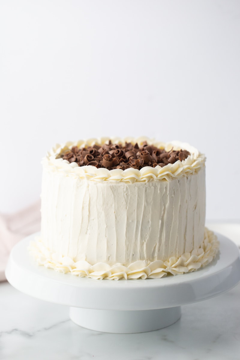 white wedding cake with chocolate shavings on top