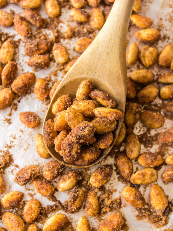 wooden spoon full of cinnamon glazed almonds