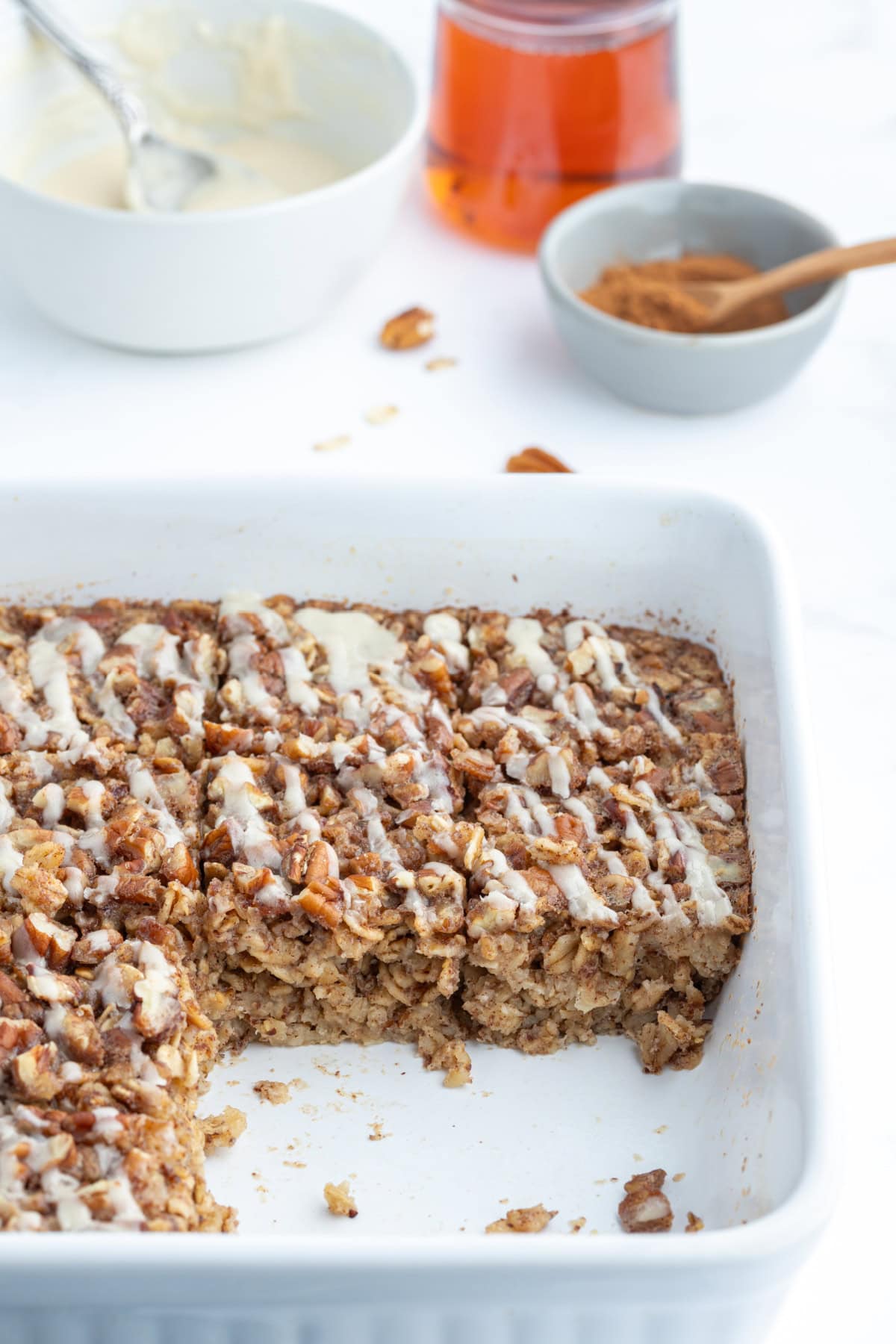 cinnamon roll baked oatmeal in dish with slices taken out