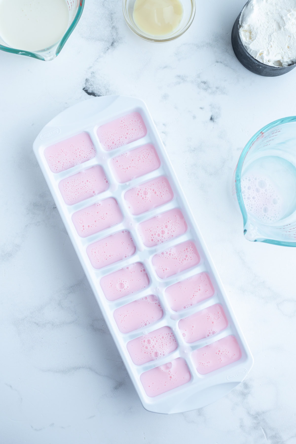 ice cube tray of strawberry milk