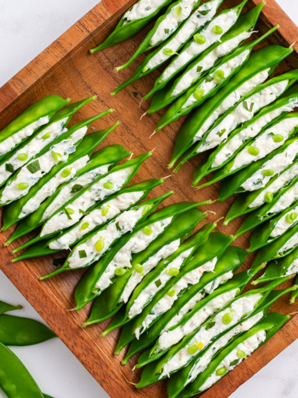 crab and cream cheese stuffed snow peas in a tray