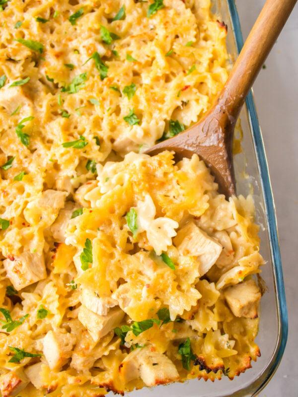 wooden spoon in pan of creamy lemon chicken pasta