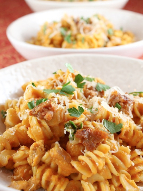 creamy pumpkin pasta with sausage in a bowl