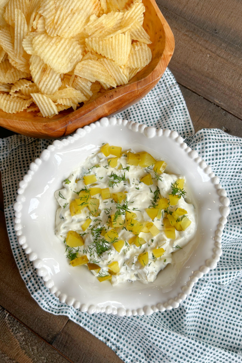 overhead shot of dill pickle dip and potato chips