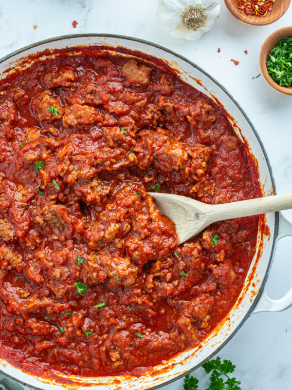 easy meat sauce in a pan with a wooden spoon