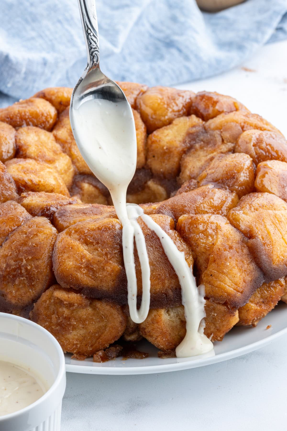 drizzling icing onto eggnog monkey bread