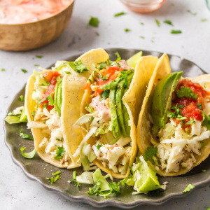 three fish tacos on a plate