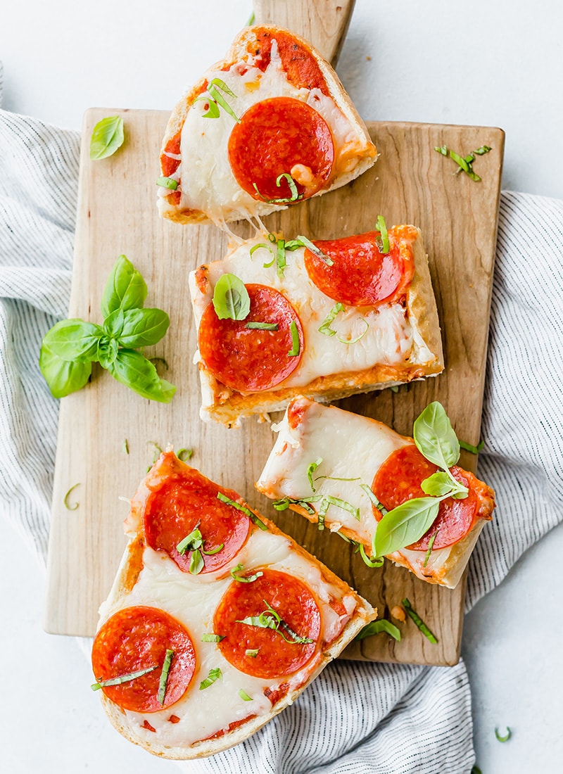 French Bread Pizza with Pepperoni and fresh basil cut into slices