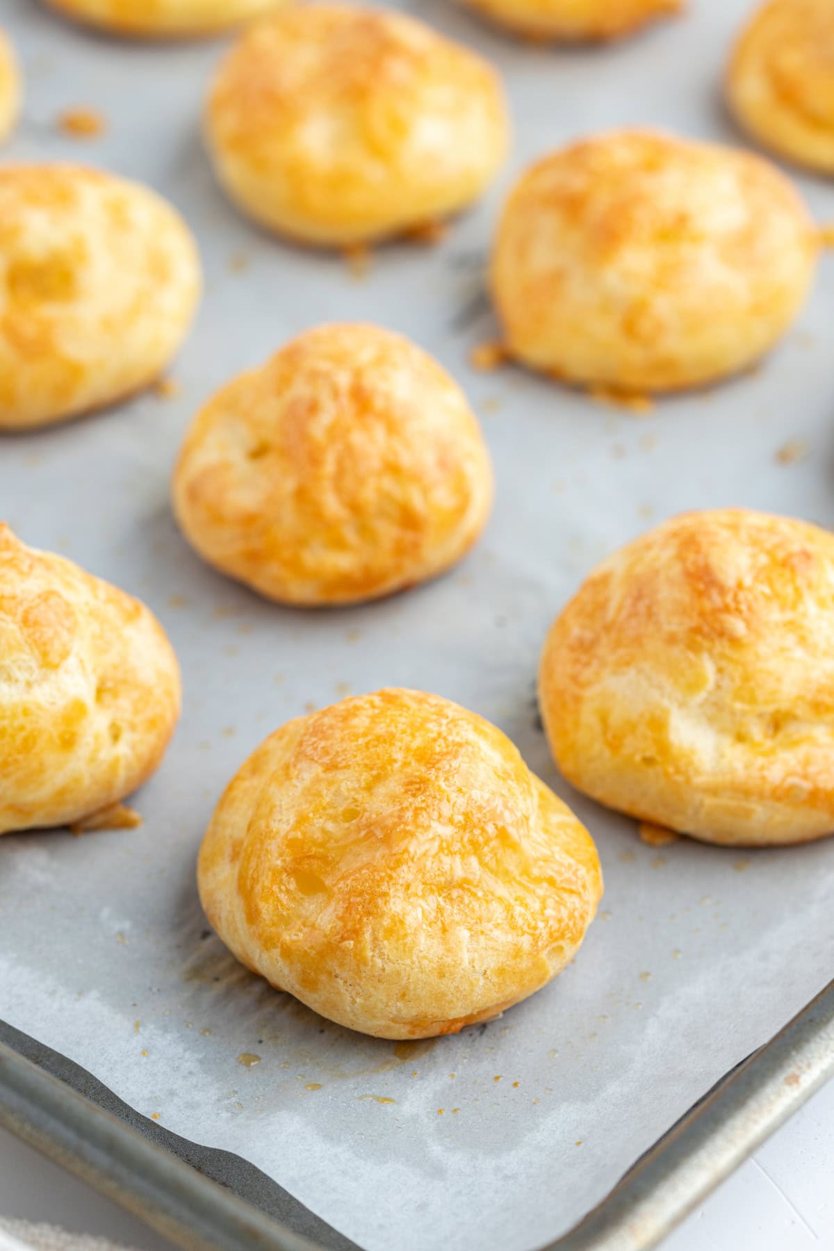 gougeres on baking sheet close up