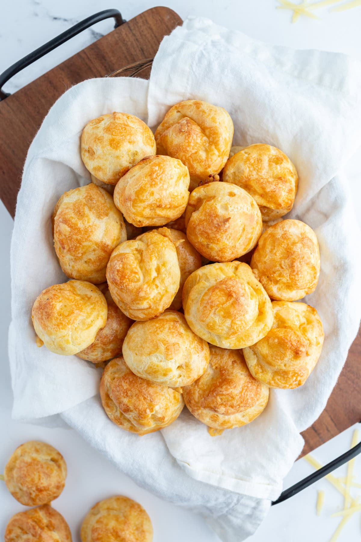 overhead shot of cloth lined basket of gougeres