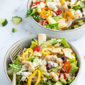 greek quinoa chopped salad in two bowls