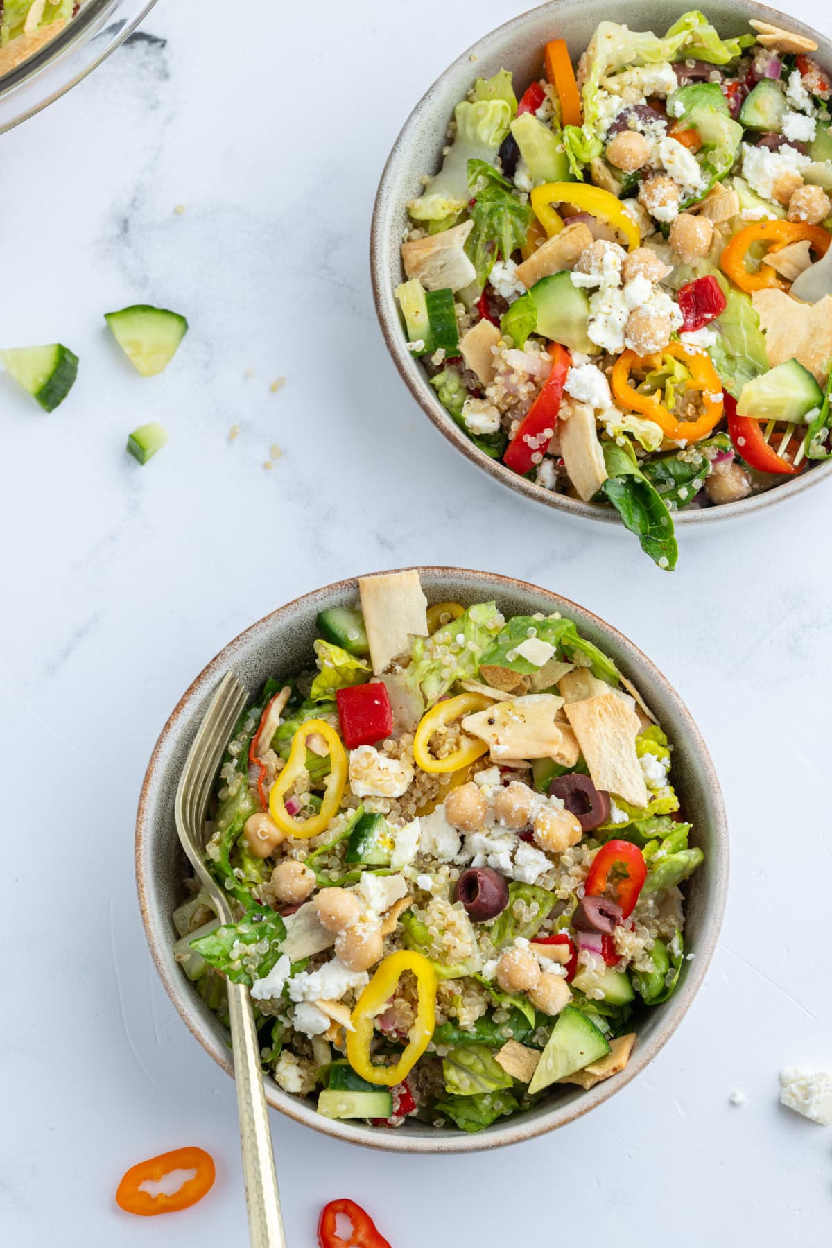 two bowls of greek quinoa chopped salad