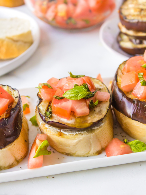 grilled eggplant open faced sandwiches on platter