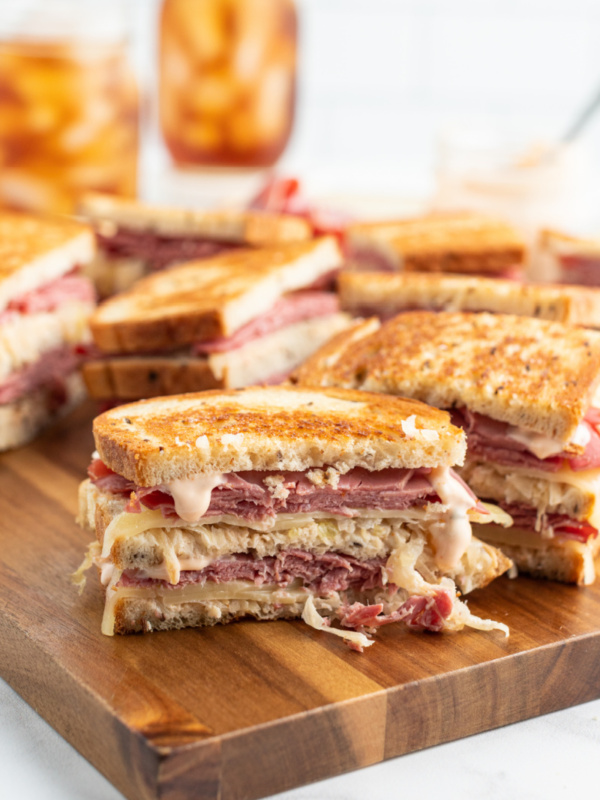 grilled reuben sandwiches on a cutting board