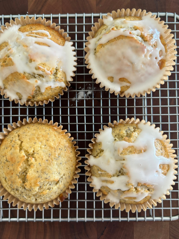 lemon poppy seed muffins on baking rack with some of them topped with glaze