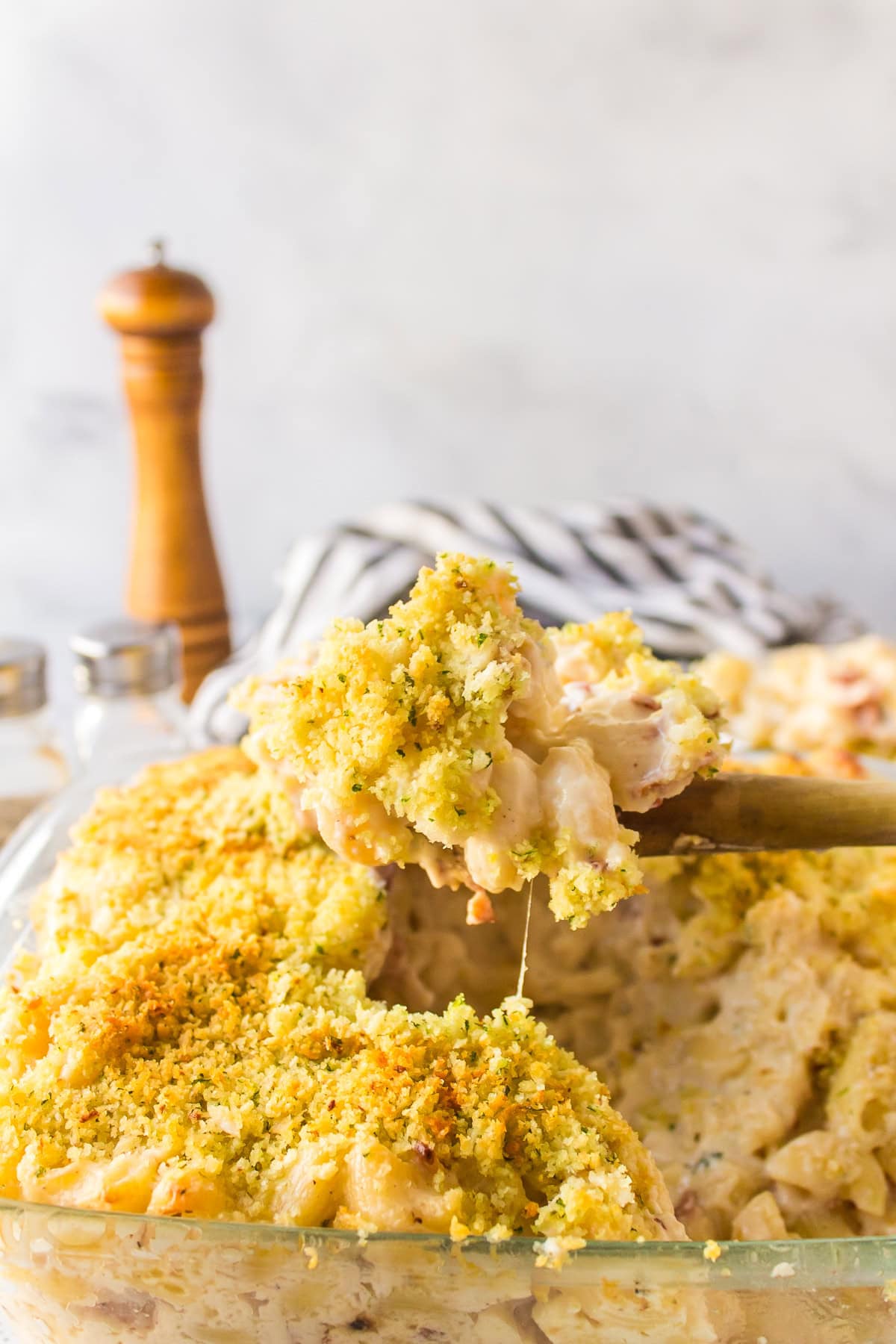 spoon lifting macaroni and cheese out of casserole dish