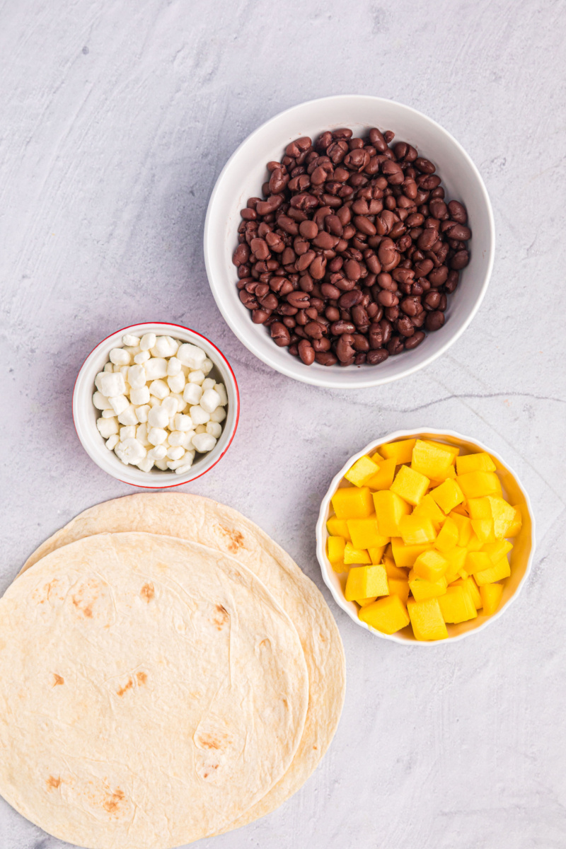 ingredients displayed for making mango black bean goat cheese quesadilla