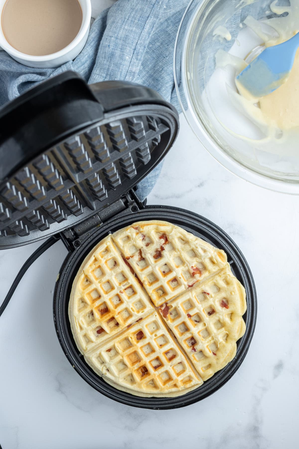 maple bacon waffle in a waffle iron