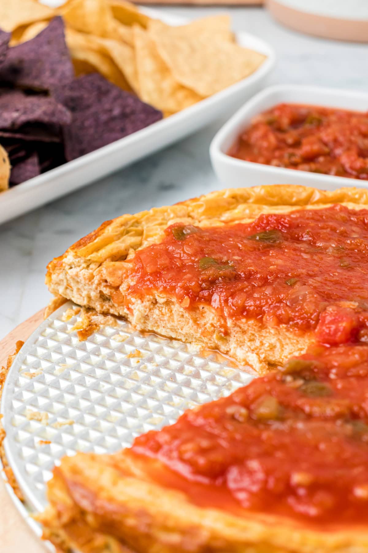 mexican cheesecake dip with big slice taken out