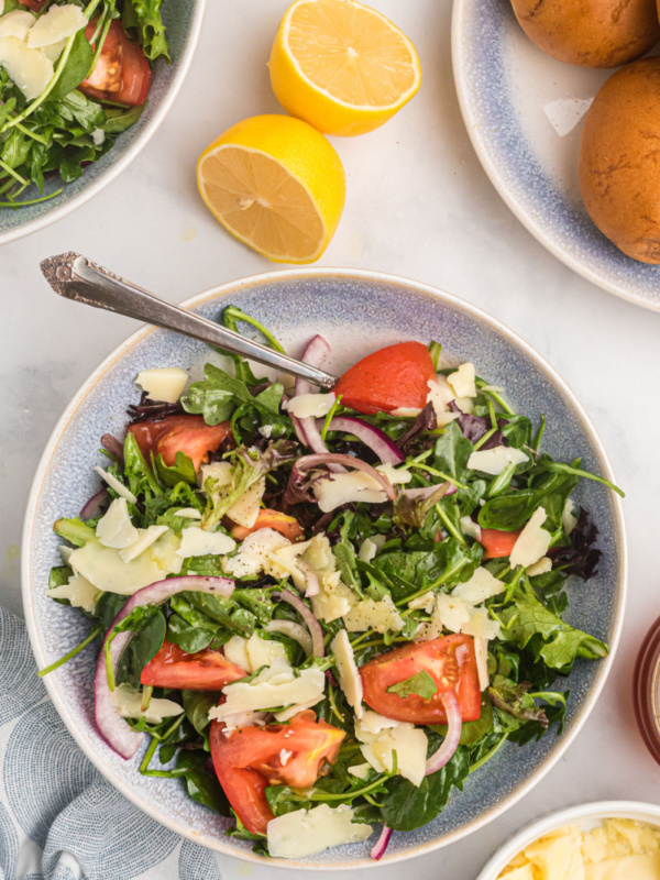 mixed green salad with honey lemon dressing in bowl