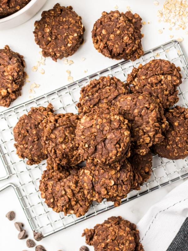 no bake chocolate peanut butter cookies stacked on cooling rack