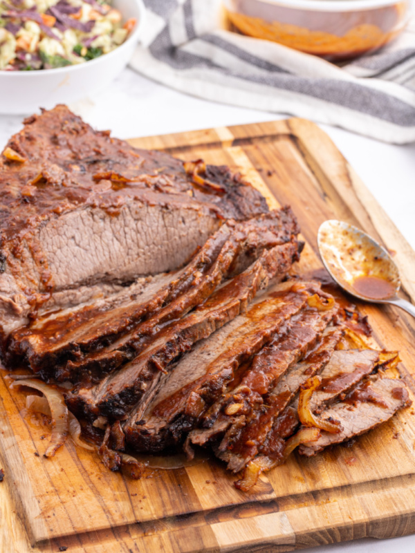 oven baked barbecue brisket on a cutting board sliced