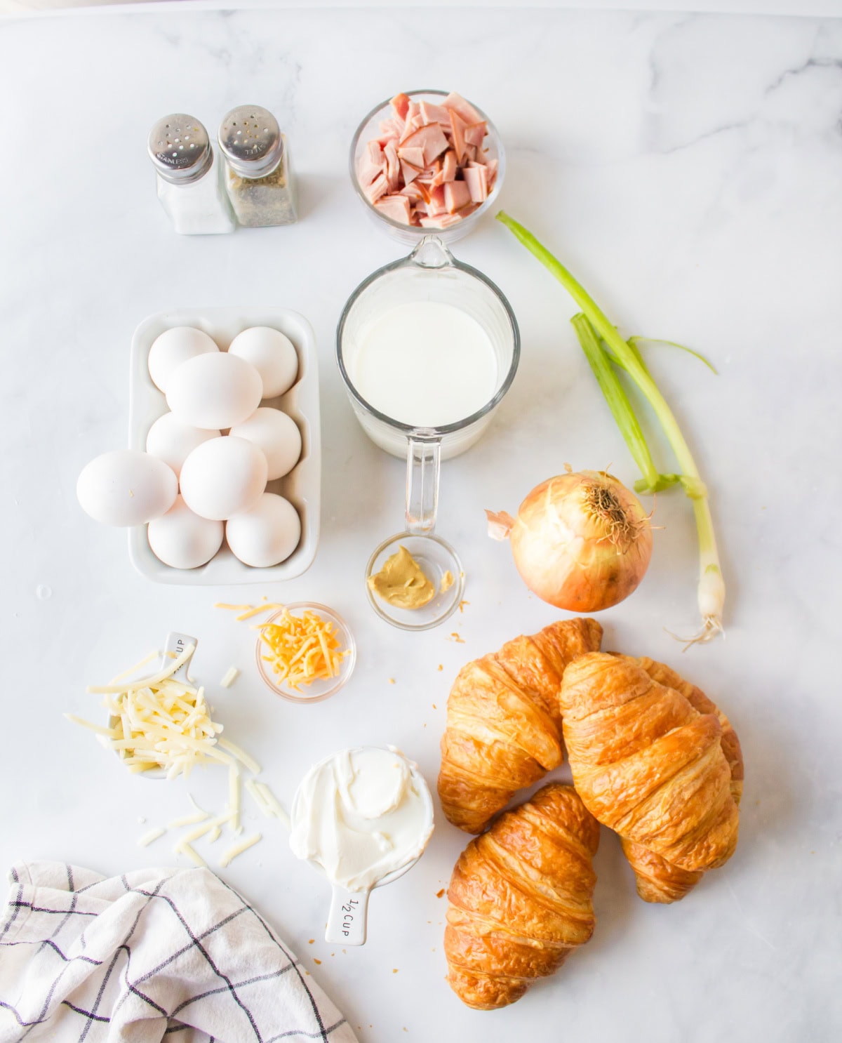 ingredients displayed for making overnight croissant ham and cheese breakfast casserole