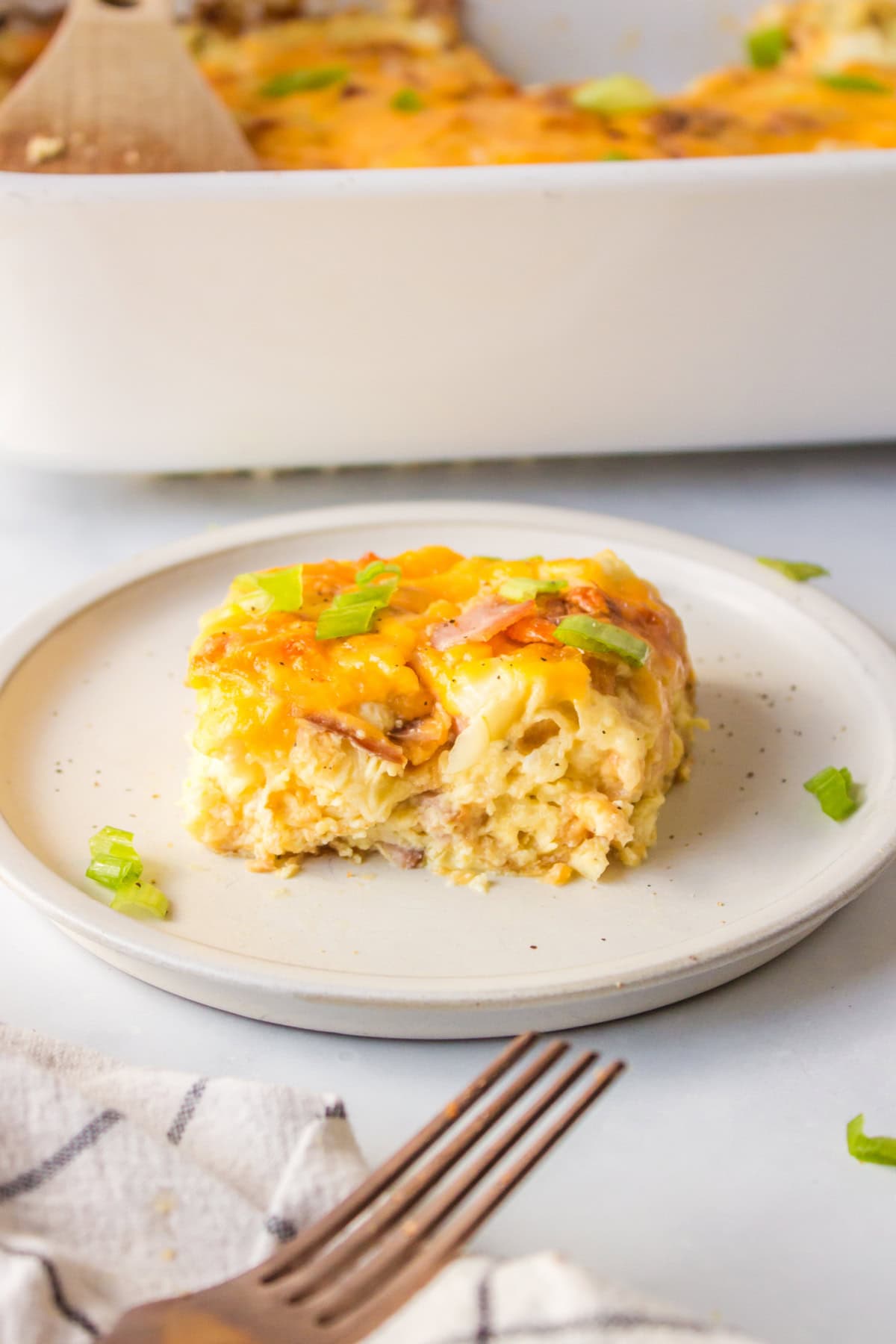 slice of overnight croissant ham and cheese breakfast casserole on plate