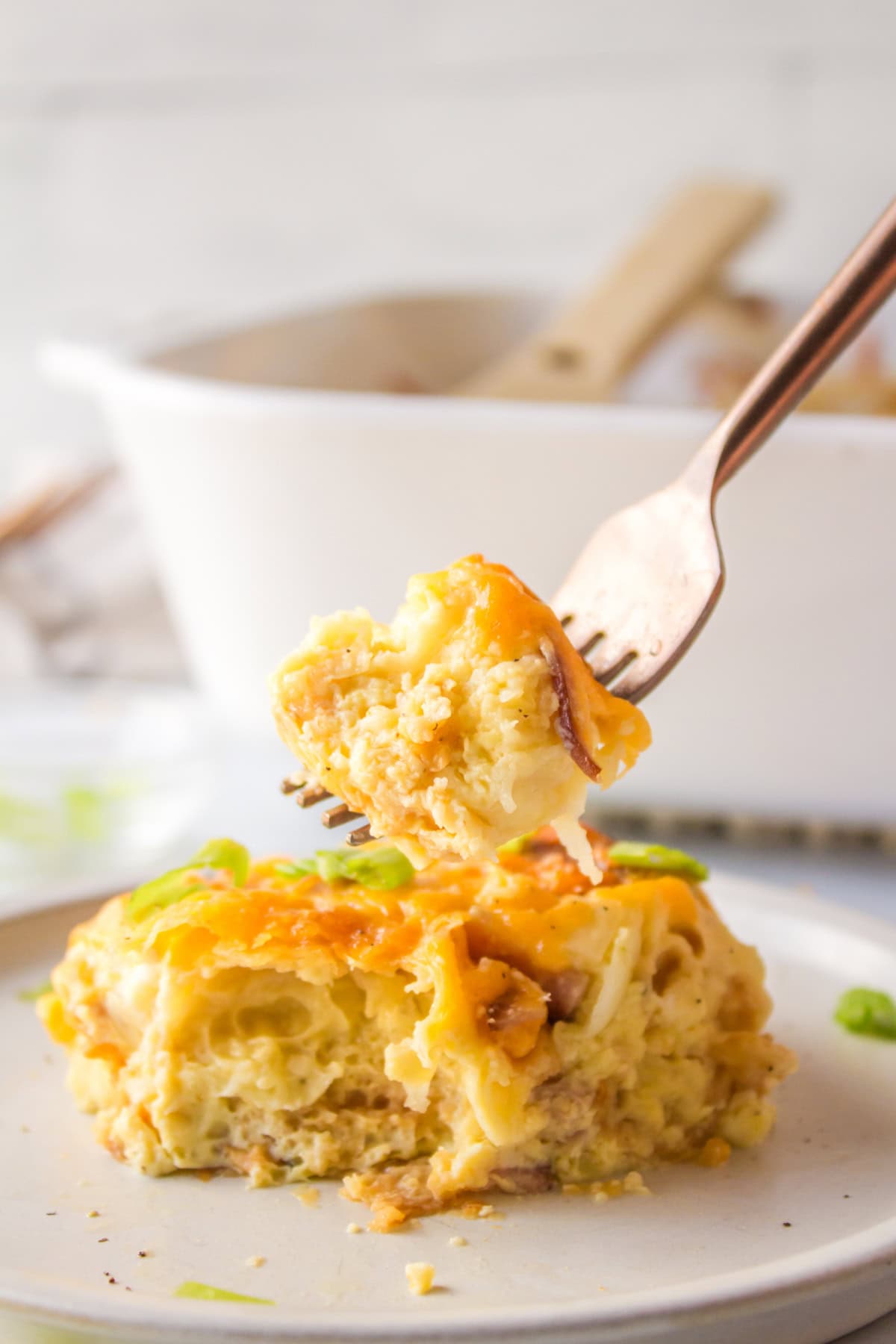 fork full of overnight croissant ham and cheese breakfast casserole