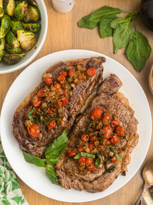 pan seared ribeye steak with balsamic onion and tomato salsa on plate